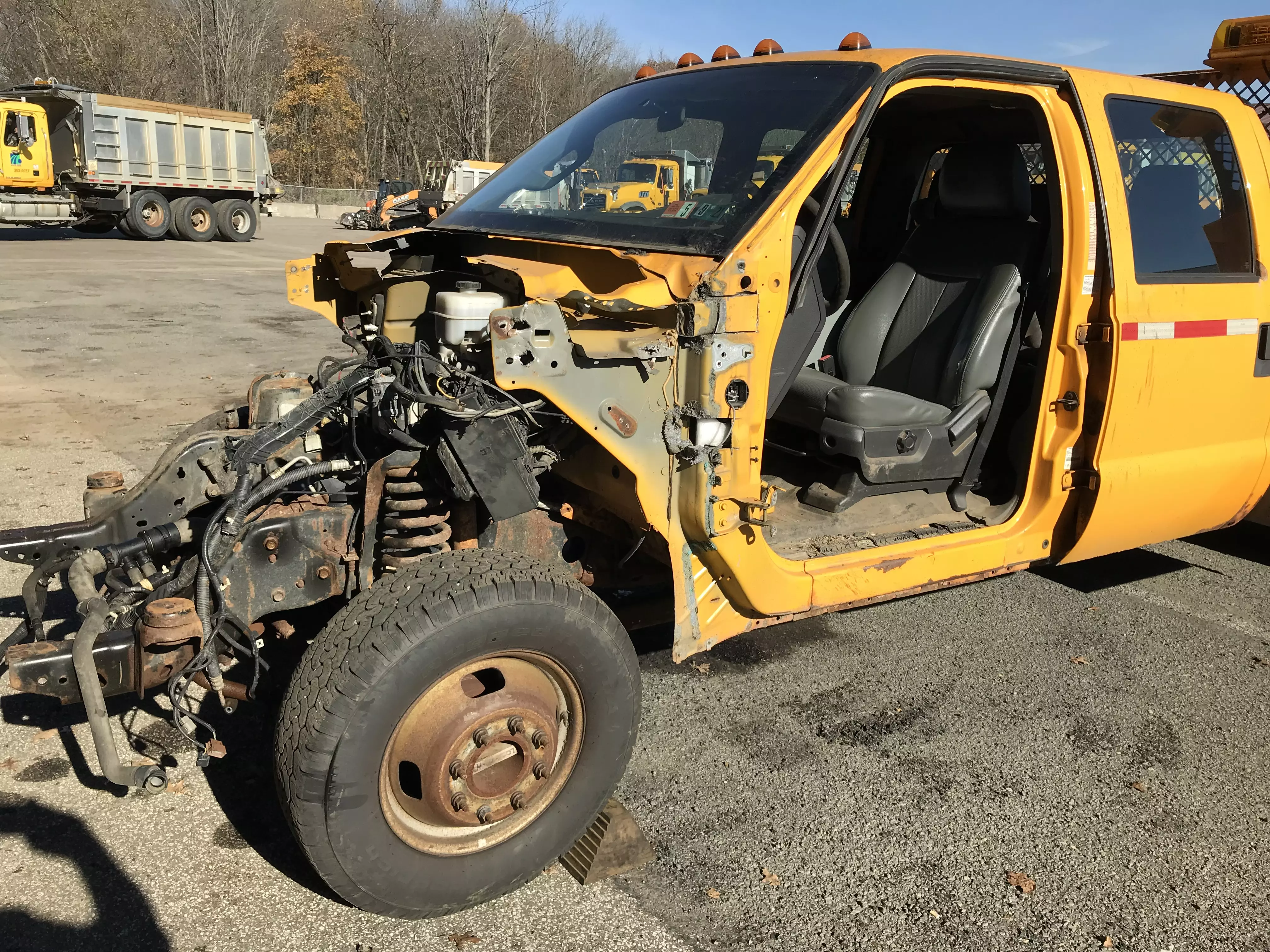 An image of a different yellow PennDOT crew cab pickup truck that has parts taken from it to be used for repairs of other PennDOT vehicles.